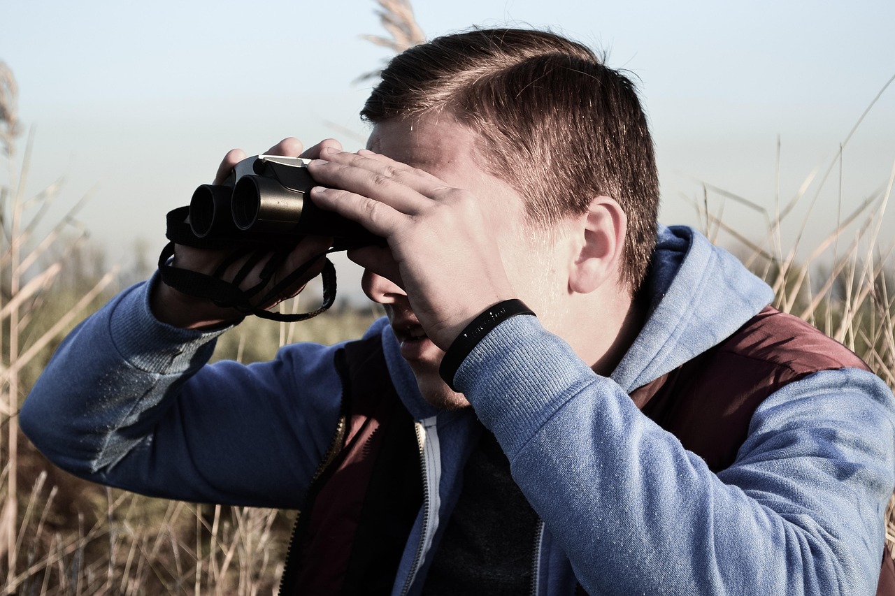 private investigator binoculars surveillance watching